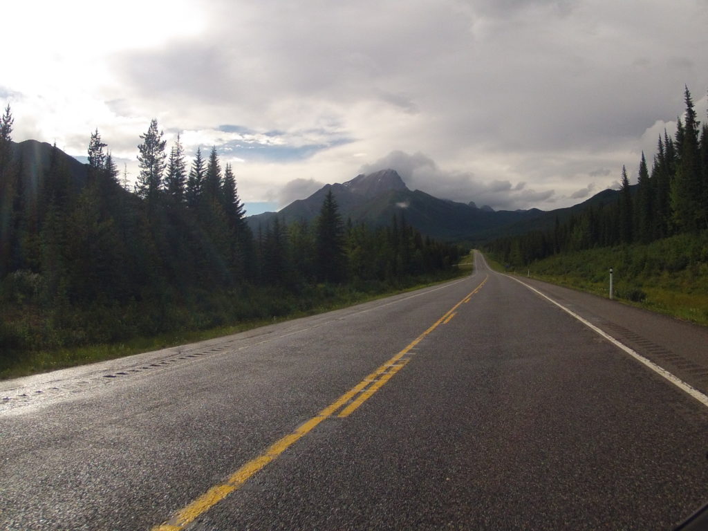 Storm clouds over the road through the mountains.