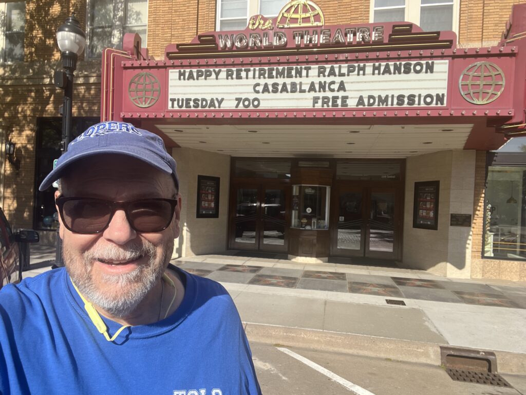 Marquee for The World Theatre with Ralph Hanson pictured. Text: HAPPY RETIREMENT RALPH HANSON, CASABLANCA, TUESDAY 700, FREE ADMISSION